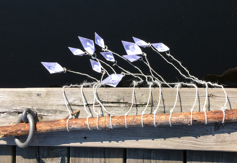 Paper boats float on lake